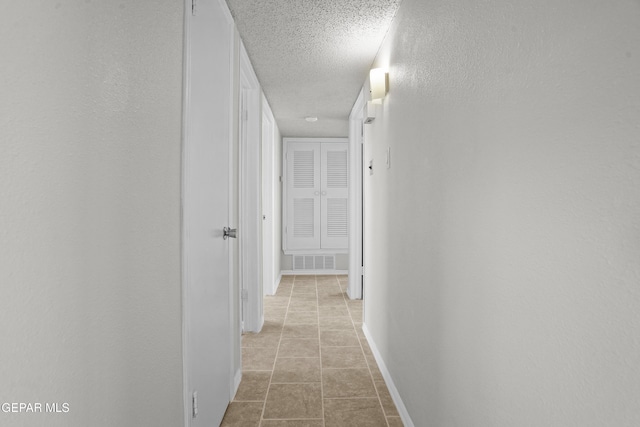 9606 Bahamas St, El Paso, TX 79927 - hallway featuring a textured ceiling and light tile patterned floors