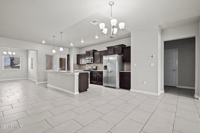 2816 Mike Price Dr, El Paso, TX 79938 - kitchen featuring a chandelier, appliances with stainless steel finishes, light countertops, backsplash, and an island with sink