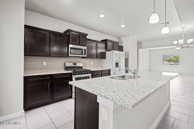 2816 Mike Price Dr, El Paso, TX 79938 - kitchen with appliances with stainless steel finishes, light tile patterned floors, and backsplash