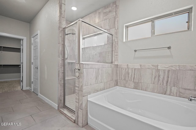 2816 Mike Price Dr, El Paso, TX 79938 - full bathroom featuring a bath, a shower stall, a walk in closet, and tile patterned flooring