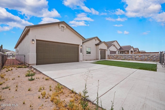 2816 Mike Price Dr, El Paso, TX 79938 - ranch-style home with stucco siding, an attached garage, and driveway