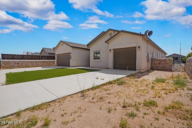 2816 Mike Price Dr, El Paso, TX 79938 - view of front of home with a gate, driveway, and an attached garage