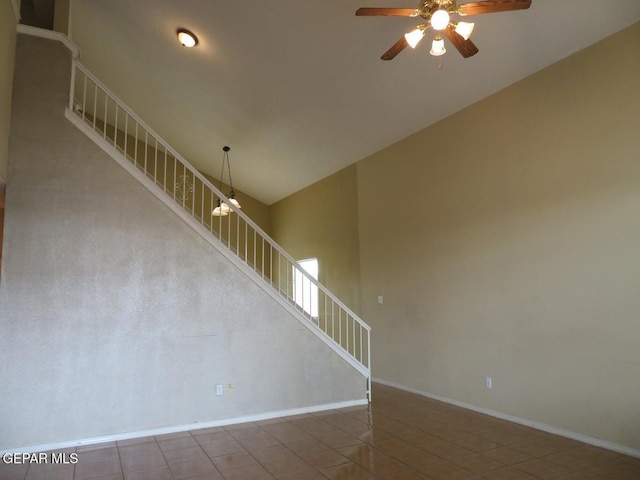 1679 Roger Bombach Dr, El Paso, TX 79936 - unfurnished living room featuring ceiling fan, stairway, tile patterned flooring, baseboards, and vaulted ceiling