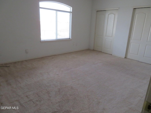 1679 Roger Bombach Dr, El Paso, TX 79936 - unfurnished bedroom with carpet flooring and multiple closets