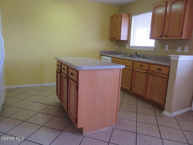 1679 Roger Bombach Dr, El Paso, TX 79936 - kitchen with light tile patterned floors, a kitchen island, light countertops, baseboards, and a sink