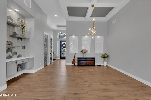 14405 Tierra Campeon, El Paso, TX 79938 - dining room with a chandelier, coffered ceiling, light wood-type flooring, a high ceiling, and baseboards