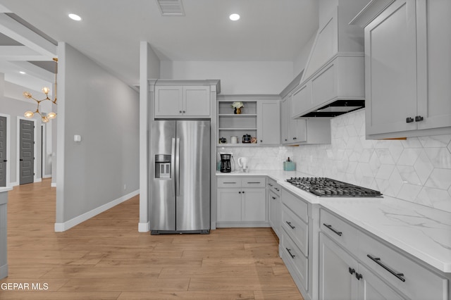 14405 Tierra Campeon, El Paso, TX 79938 - kitchen with stainless steel appliances, open shelves, premium range hood, decorative backsplash, and light wood-type flooring