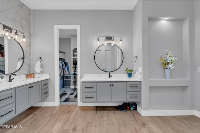 14405 Tierra Campeon, El Paso, TX 79938 - full bath with wood finished floors, two vanities, a spacious closet, and baseboards