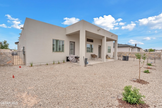 14405 Tierra Campeon, El Paso, TX 79938 - rear view of property featuring a gate, stucco siding, a fenced backyard, and a patio