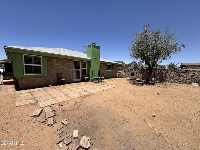 6696 Tiger Eye Dr, El Paso, TX 79924 - back of property with a fenced backyard, a chimney, a patio area, and brick siding