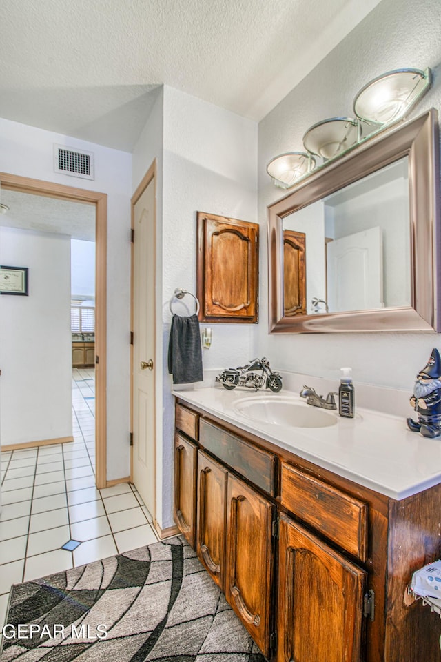 1809 Garden Gate Way, El Paso, TX 79936 - bathroom featuring vanity, tile patterned floors, and a textured ceiling