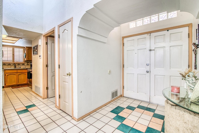 1809 Garden Gate Way, El Paso, TX 79936 - entrance foyer with light tile patterned floors and arched walkways