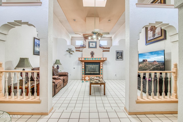 1809 Garden Gate Way, El Paso, TX 79936 - living room featuring tile patterned flooring, a glass covered fireplace, ceiling fan, and ornamental molding