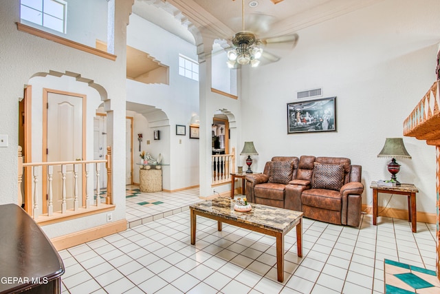 1809 Garden Gate Way, El Paso, TX 79936 - living area featuring arched walkways, a ceiling fan, light tile patterned floors, and a high ceiling