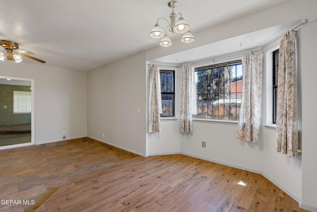 10749 Rushing Rd, El Paso, TX 79924 - empty room featuring wood finished floors, a chandelier, a ceiling fan, and baseboards
