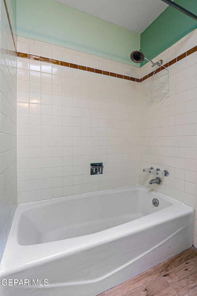 10749 Rushing Rd, El Paso, TX 79924 - bathroom with wood finished floors and shower / washtub combination