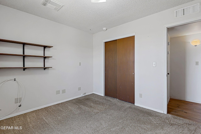 10749 Rushing Rd, El Paso, TX 79924 - unfurnished bedroom with carpet floors, a closet, baseboards, and a textured ceiling