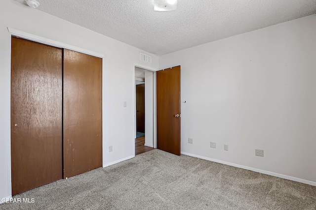 10749 Rushing Rd, El Paso, TX 79924 - unfurnished bedroom with carpet, a closet, baseboards, and a textured ceiling