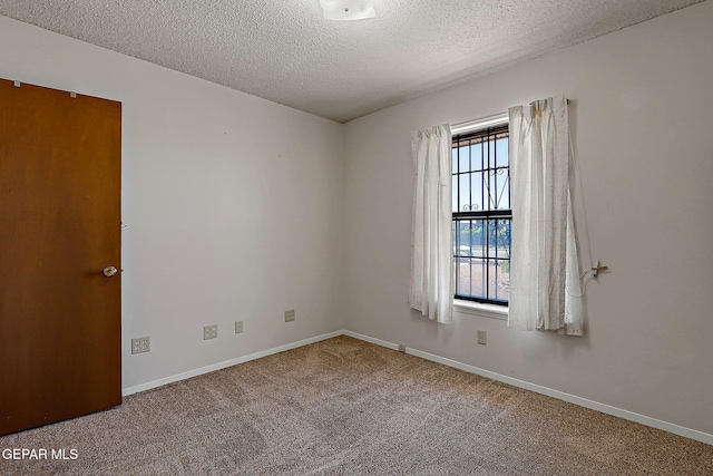 10749 Rushing Rd, El Paso, TX 79924 - carpeted spare room featuring a textured ceiling and baseboards