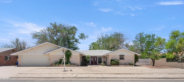 8820 Dirk Ct, El Paso, TX 79925 - single story home featuring driveway, brick siding, and an attached garage