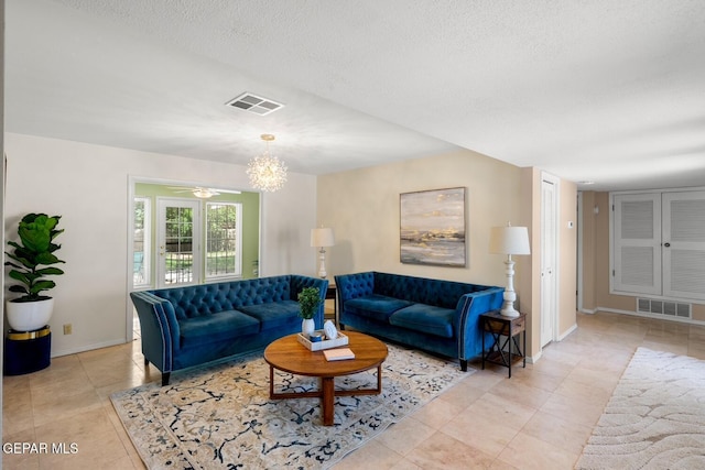 8820 Dirk Ct, El Paso, TX 79925 - living room with light tile patterned flooring, a chandelier, a textured ceiling, and a ceiling fan