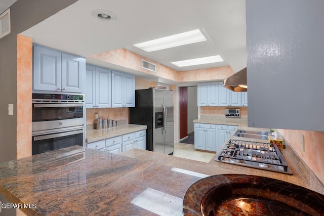 8820 Dirk Ct, El Paso, TX 79925 - kitchen featuring appliances with stainless steel finishes and range hood