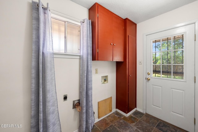8820 Dirk Ct, El Paso, TX 79925 - laundry room with electric dryer hookup, stone tile floors, cabinet space, washer hookup, and a textured ceiling