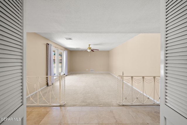 8820 Dirk Ct, El Paso, TX 79925 - carpeted spare room featuring ceiling fan, a textured ceiling, and tile patterned floors