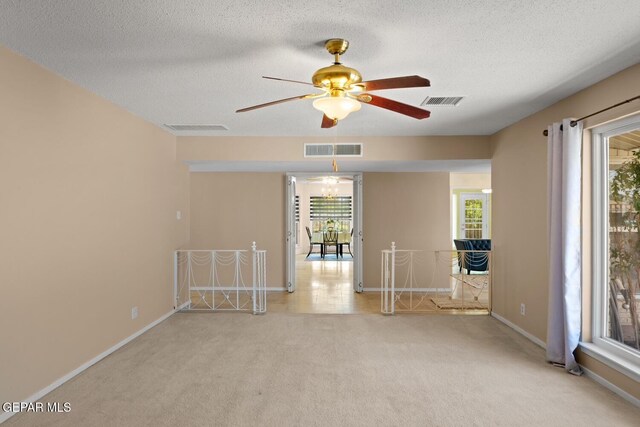 8820 Dirk Ct, El Paso, TX 79925 - carpeted spare room featuring ceiling fan and a textured ceiling