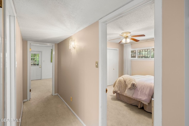 8820 Dirk Ct, El Paso, TX 79925 - hallway with a textured ceiling and light colored carpet