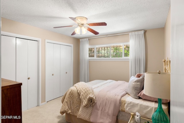 8820 Dirk Ct, El Paso, TX 79925 - carpeted bedroom with two closets, a textured ceiling, and ceiling fan