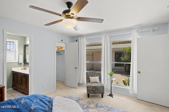 8820 Dirk Ct, El Paso, TX 79925 - bedroom featuring light carpet, multiple windows, a spacious closet, and connected bathroom