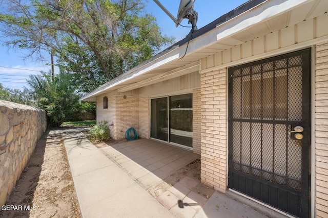 8820 Dirk Ct, El Paso, TX 79925 - property entrance featuring brick siding and a patio area
