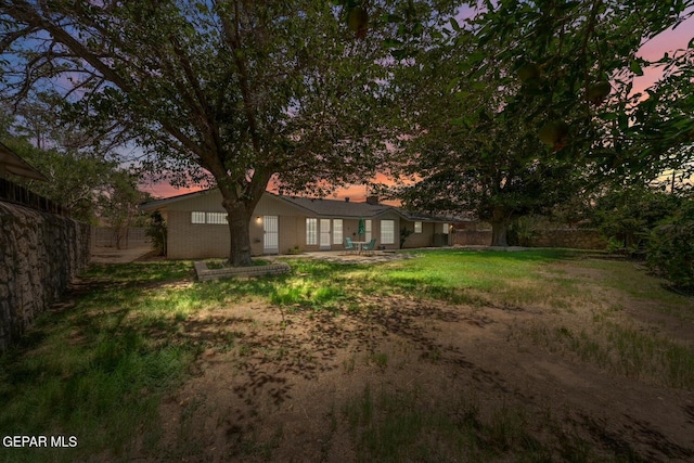 8820 Dirk Ct, El Paso, TX 79925 - back of property at dusk featuring a patio area and a chimney