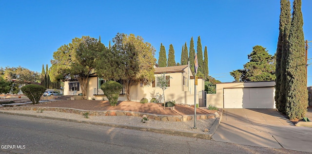 818 Kerbey Ave, El Paso, TX 79902 - view of front of house with stucco siding, a garage, and concrete driveway