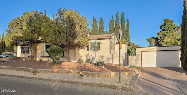 818 Kerbey Ave, El Paso, TX 79902 - view of front of house with stucco siding, a garage, and concrete driveway