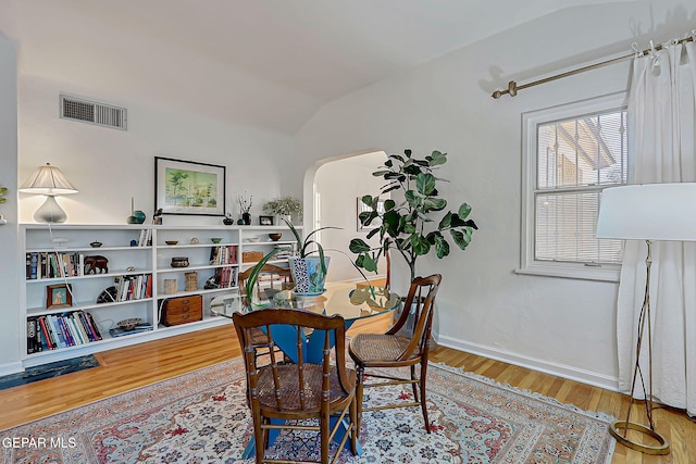 818 Kerbey Ave, El Paso, TX 79902 - home office featuring wood finished floors, vaulted ceiling, arched walkways, and baseboards