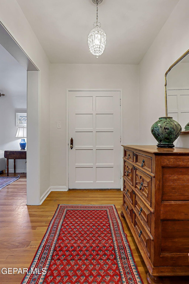 818 Kerbey Ave, El Paso, TX 79902 - entrance foyer with light wood-style floors, a chandelier, and baseboards