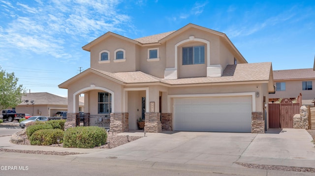 2201 Morning Mist Pl, El Paso, TX 79938 - view of front facade featuring stone siding, an attached garage, stucco siding, covered porch, and driveway