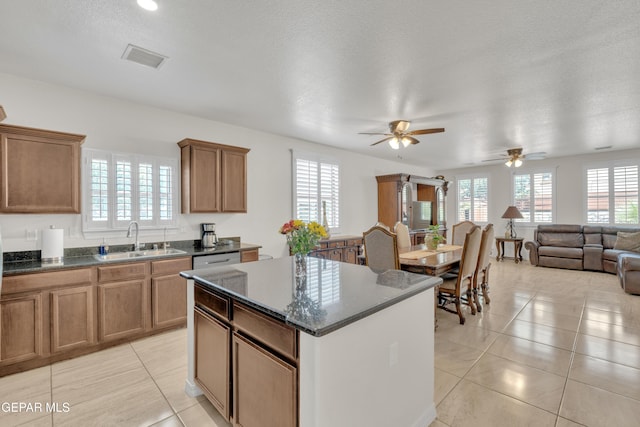 2201 Morning Mist Pl, El Paso, TX 79938 - kitchen featuring a sink, a kitchen island, light tile patterned flooring, brown cabinets, and a ceiling fan