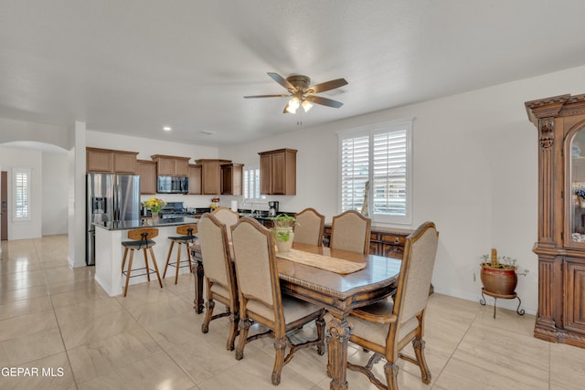 2201 Morning Mist Pl, El Paso, TX 79938 - dining area with arched walkways, ceiling fan, and baseboards