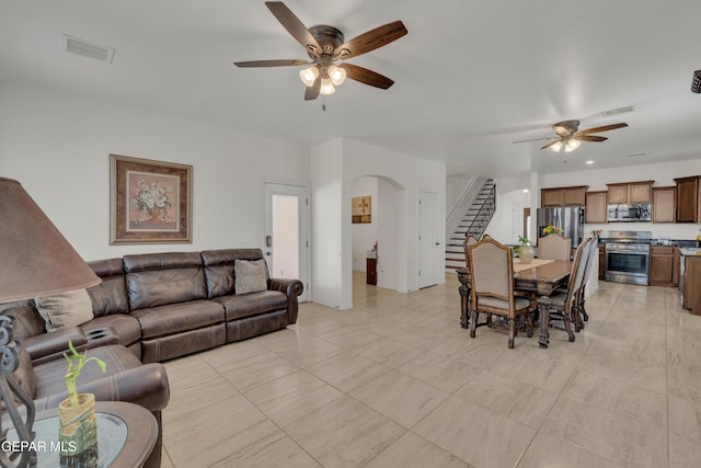 2201 Morning Mist Pl, El Paso, TX 79938 - living room with a ceiling fan, stairs, and arched walkways