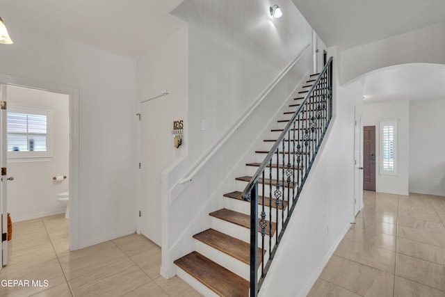 2201 Morning Mist Pl, El Paso, TX 79938 - stairs featuring arched walkways, tile patterned floors, healthy amount of natural light, and baseboards