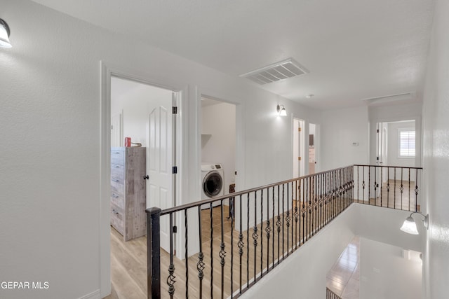 2201 Morning Mist Pl, El Paso, TX 79938 - hall with an upstairs landing, washer / dryer, and wood finished floors