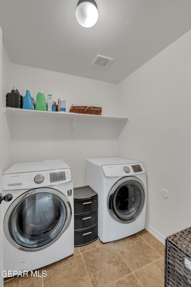 2201 Morning Mist Pl, El Paso, TX 79938 - laundry room featuring separate washer and dryer, a textured ceiling, baseboards, and light tile patterned flooring