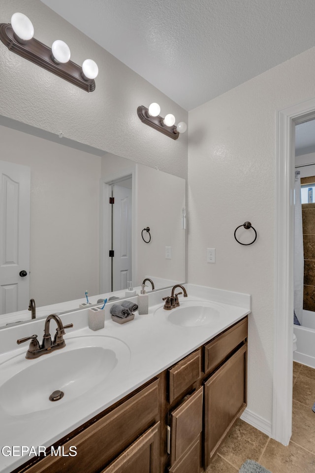 2201 Morning Mist Pl, El Paso, TX 79938 - full bath featuring double vanity, a textured ceiling, tile patterned flooring, and shower / bath combination with curtain