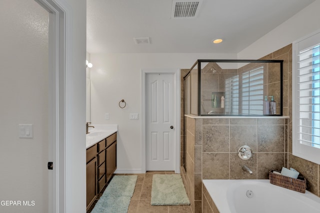 2201 Morning Mist Pl, El Paso, TX 79938 - full bathroom featuring double vanity, a bath, a stall shower, tile patterned flooring, and healthy amount of natural light