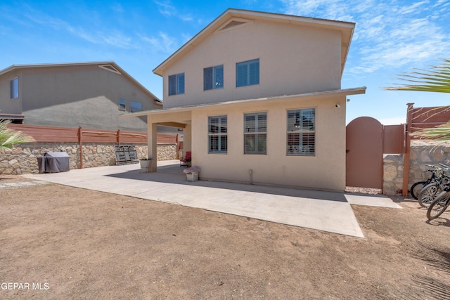 2201 Morning Mist Pl, El Paso, TX 79938 - back of house featuring stucco siding, a patio area, and a gate