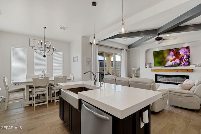 974 Airship Pl, Horizon City, TX 79928 - kitchen featuring stainless steel dishwasher, a sink, open floor plan, a chandelier, and ceiling fan