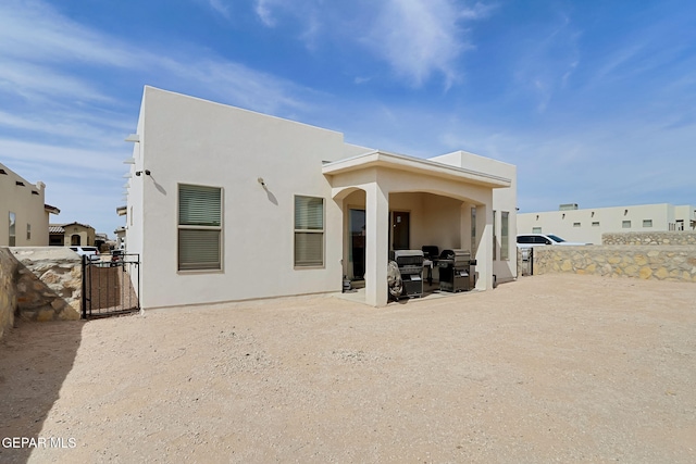 974 Airship Pl, Horizon City, TX 79928 - rear view of house with a patio, stucco siding, and a gate